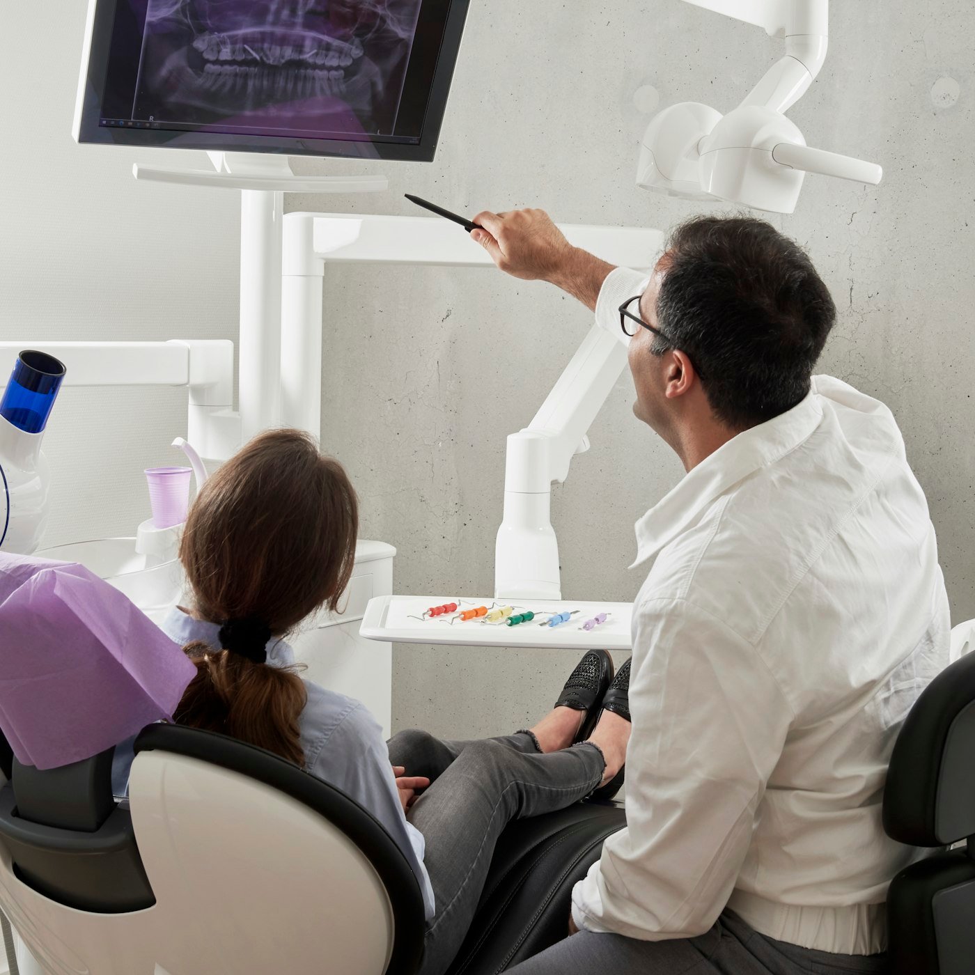 Dentist reviewing a dental image with a patient
